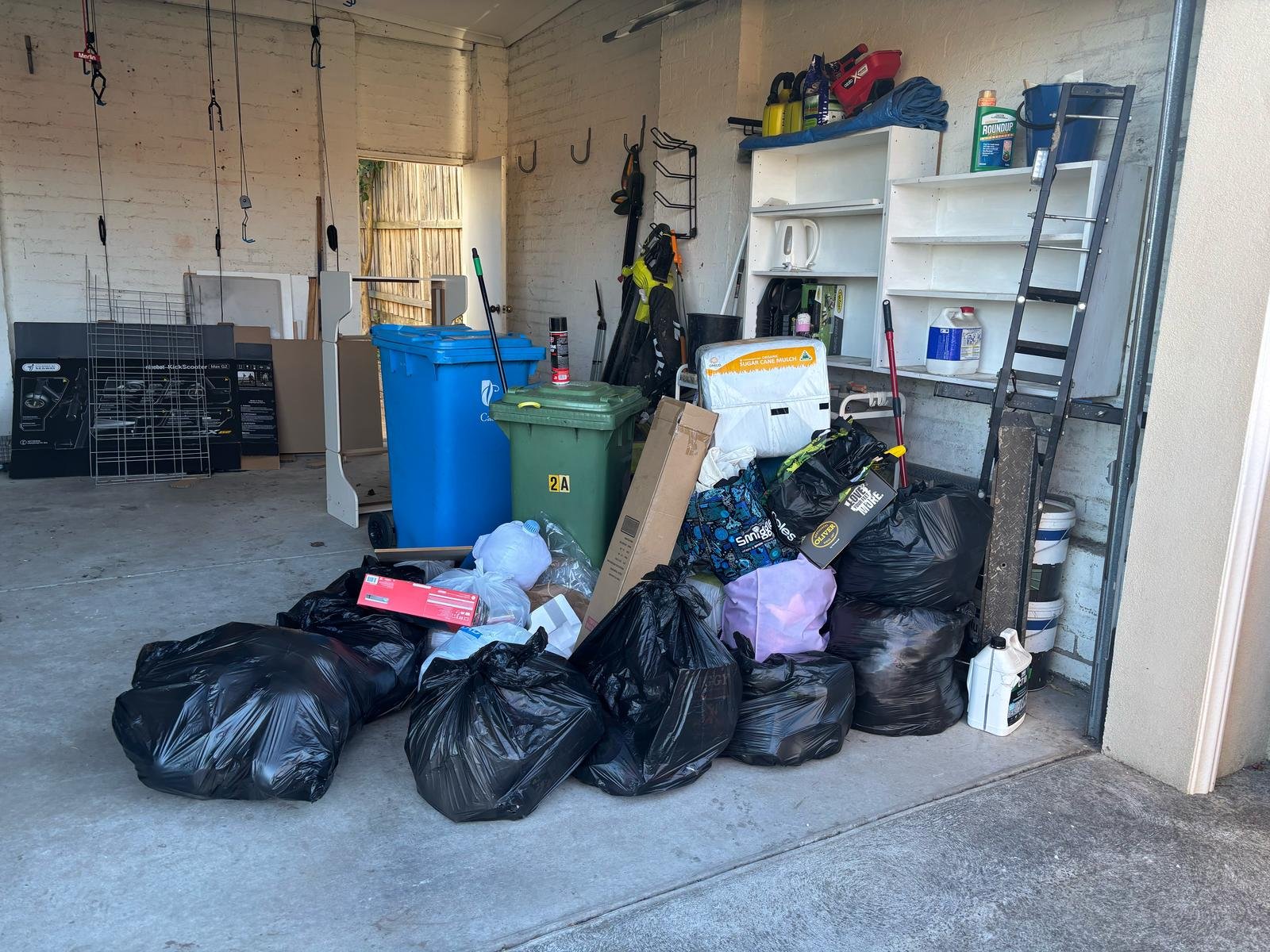 a pile of garbage bags in a garage.About Rubbish Removal Melbourne